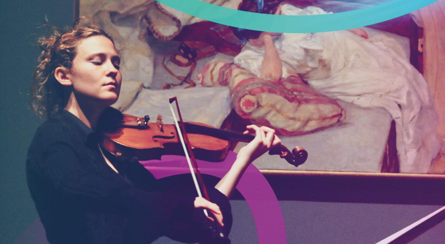 A young white woman with curly blonde hair plays a violin in front of a painting of a woman reclining