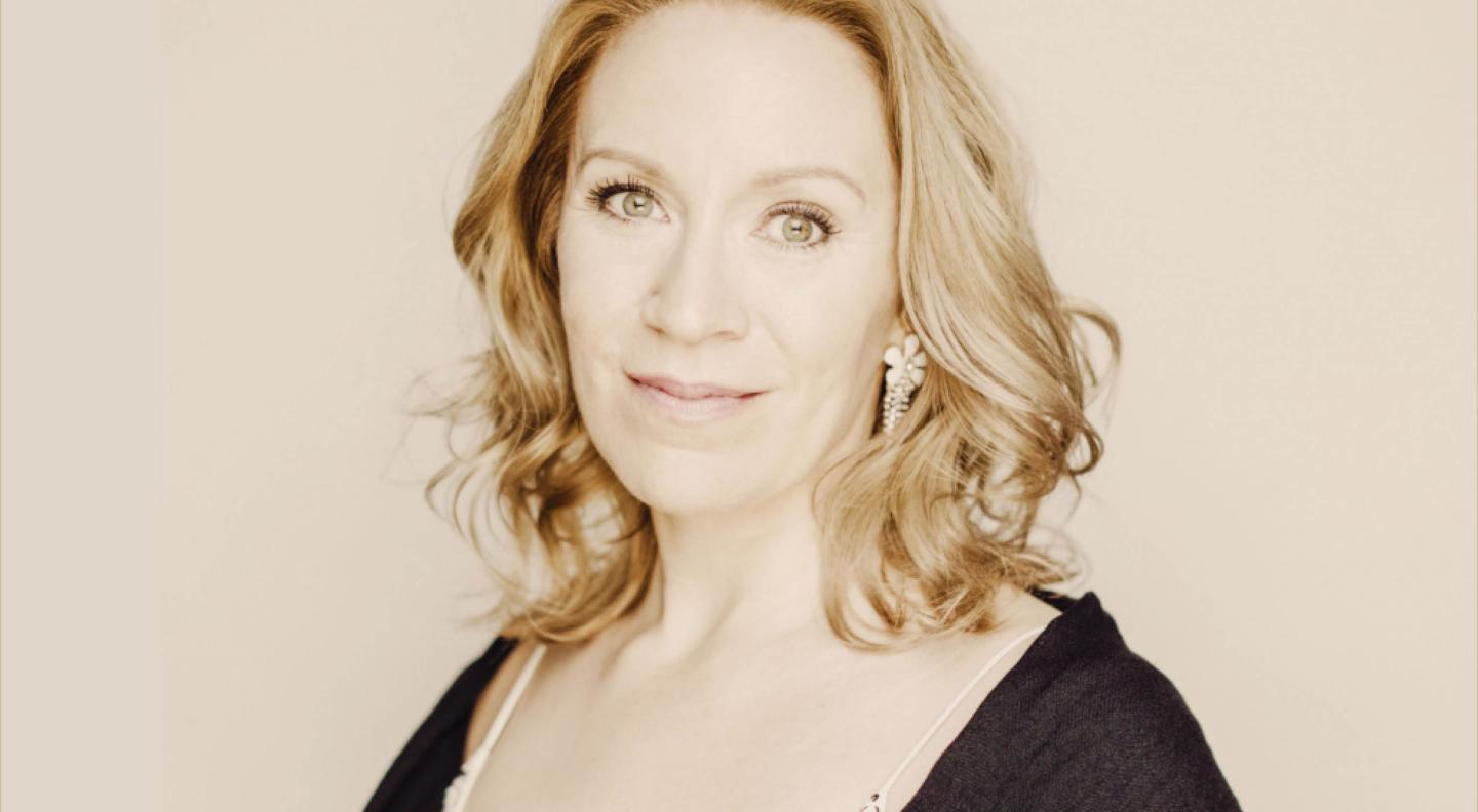 An image of  Carolyn Sampson, a white woman with blonde hair, against a cream background