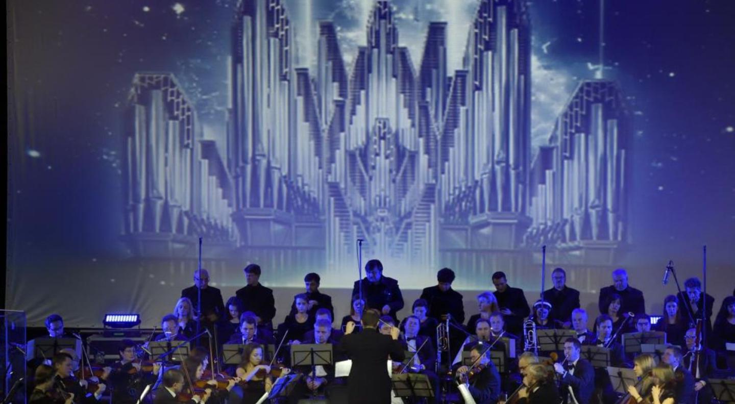 Music of Hans Zimmer being performed live on stage by an orchestra