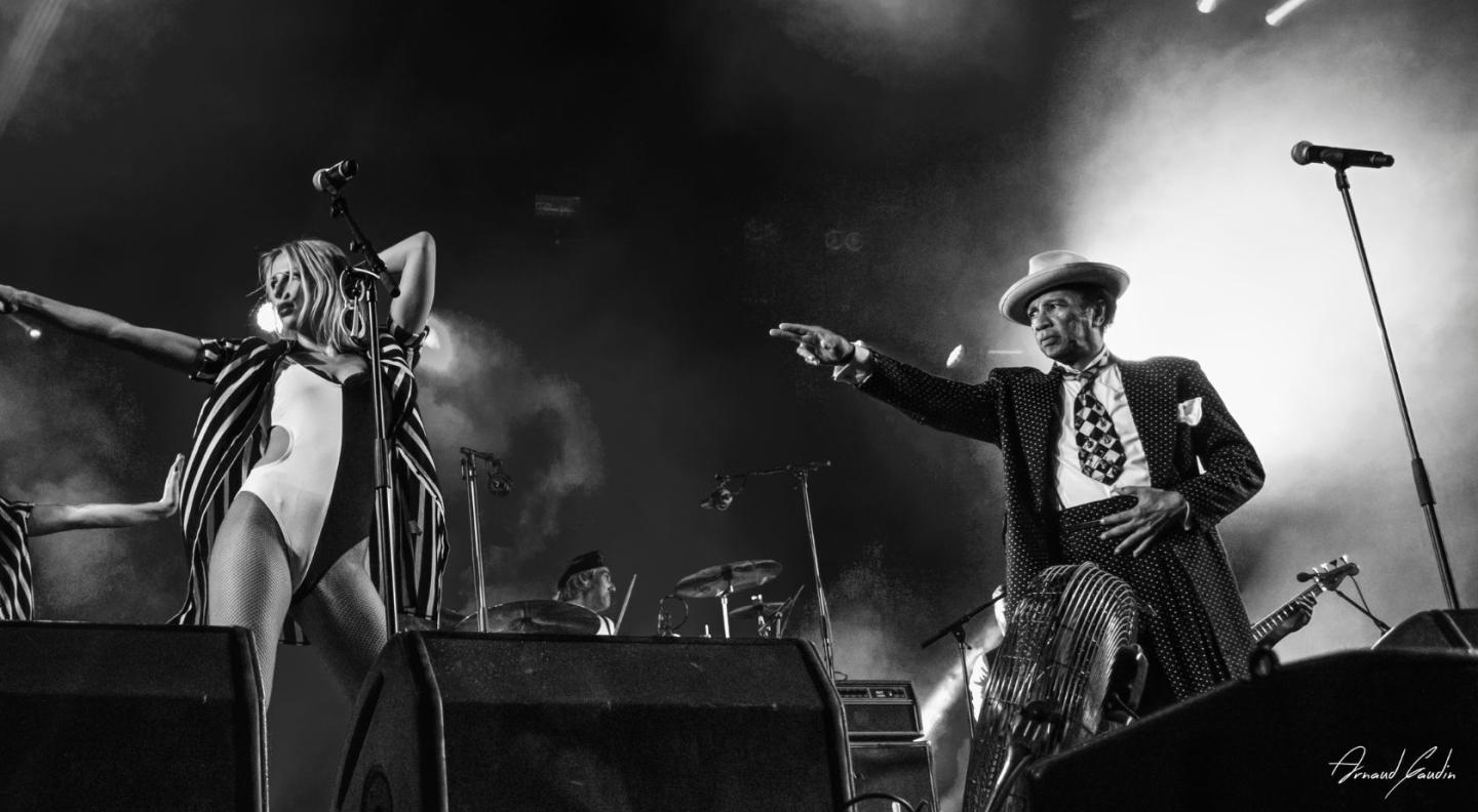 Kid Creole on stage in black and white