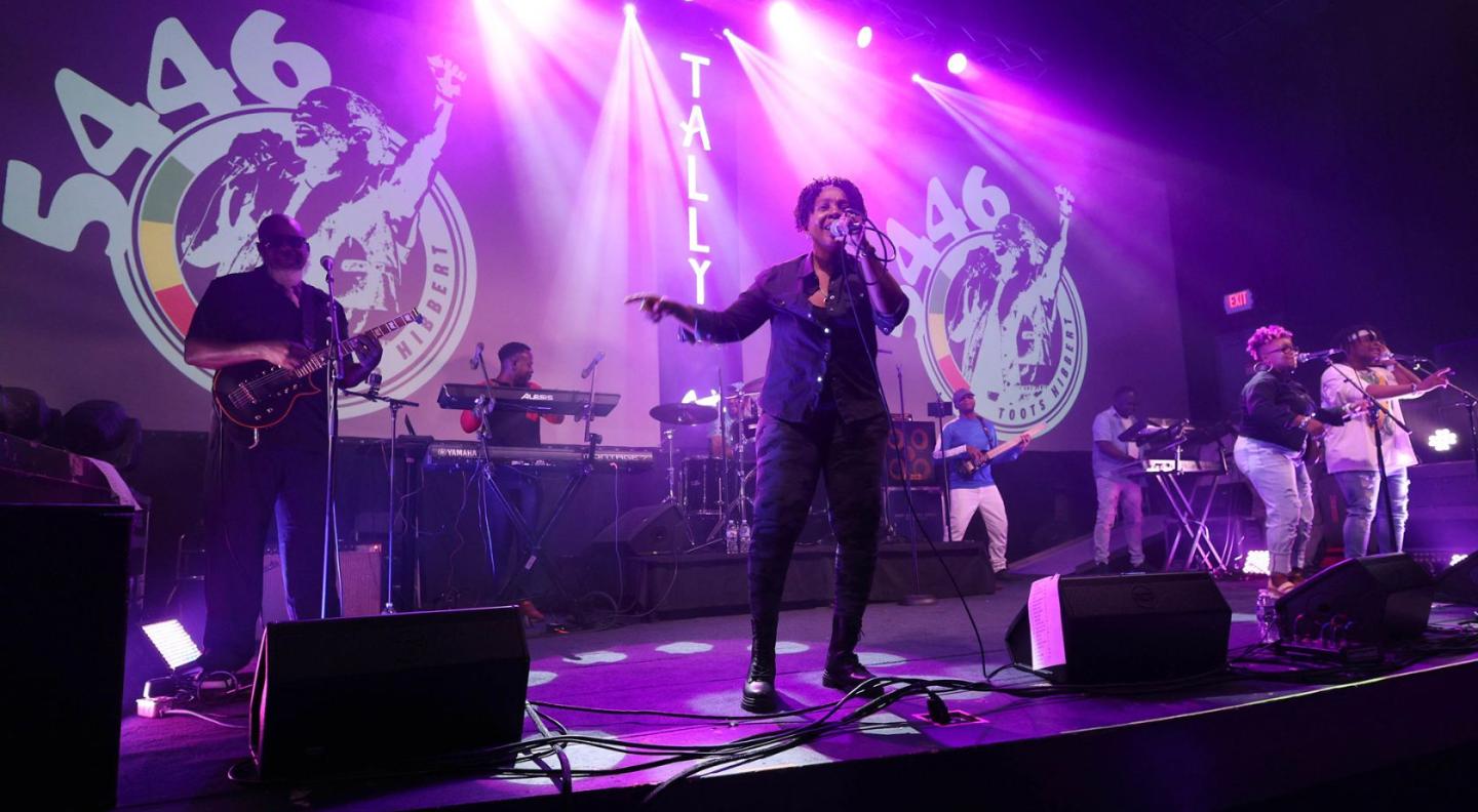 an image of the band onstage under purple lights